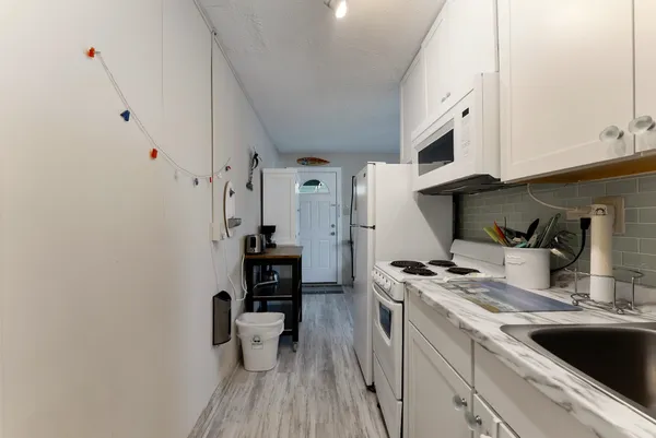 a kitchen with stainless steel appliances a sink a stove and cabinets