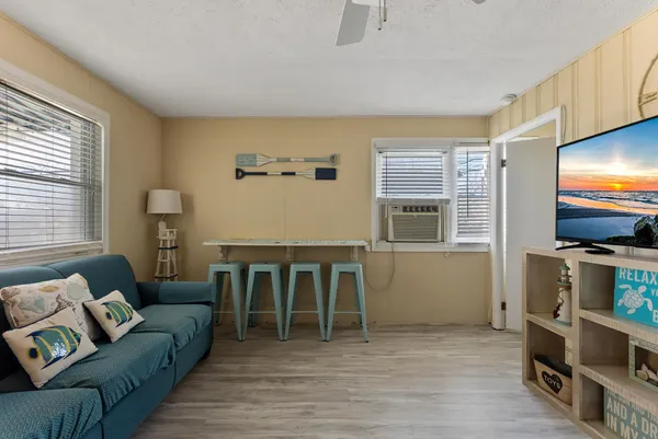 a living room with furniture and a wooden floor