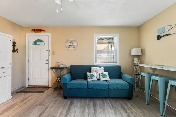 a living room with furniture and a wooden floor