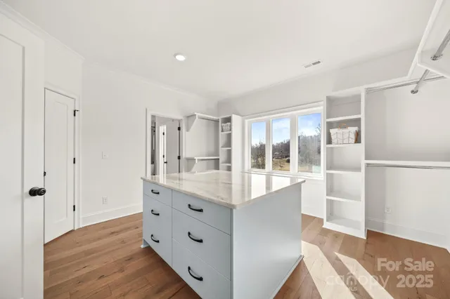 a large white kitchen with a window