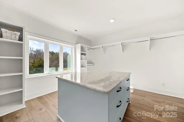 a bathroom with a granite countertop sink and a shower