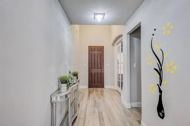 a view of hallway with wooden floor