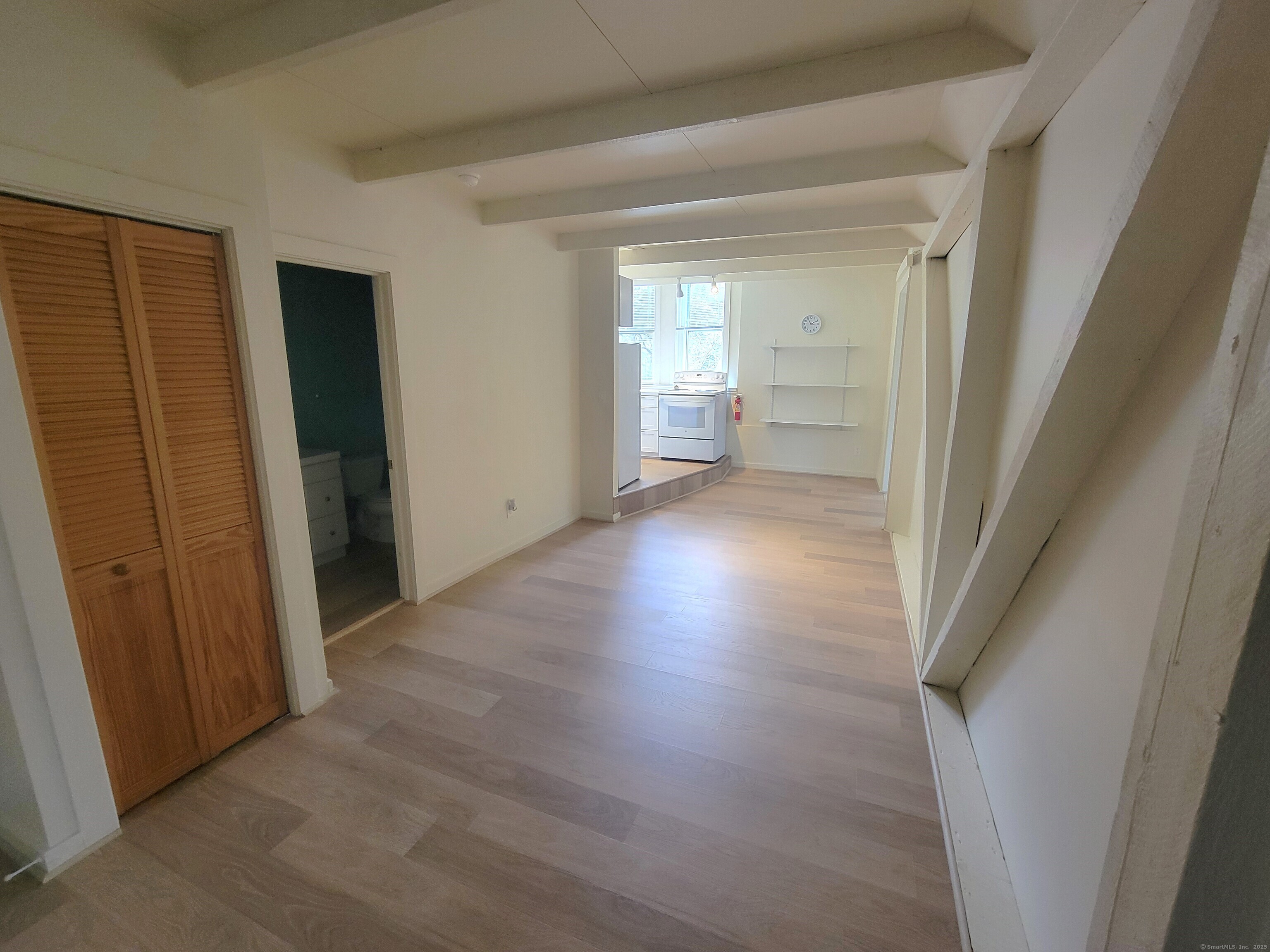 270 Cherry Brook Road, Unit 3 Canton, CT 06019 - Photo 2 of 13 a view of an empty room with wooden floor and a window