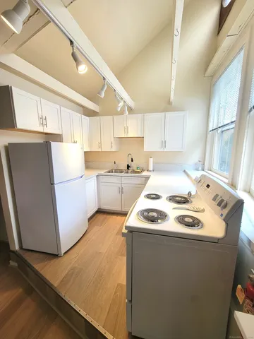 a kitchen with a stove a sink and a refrigerator