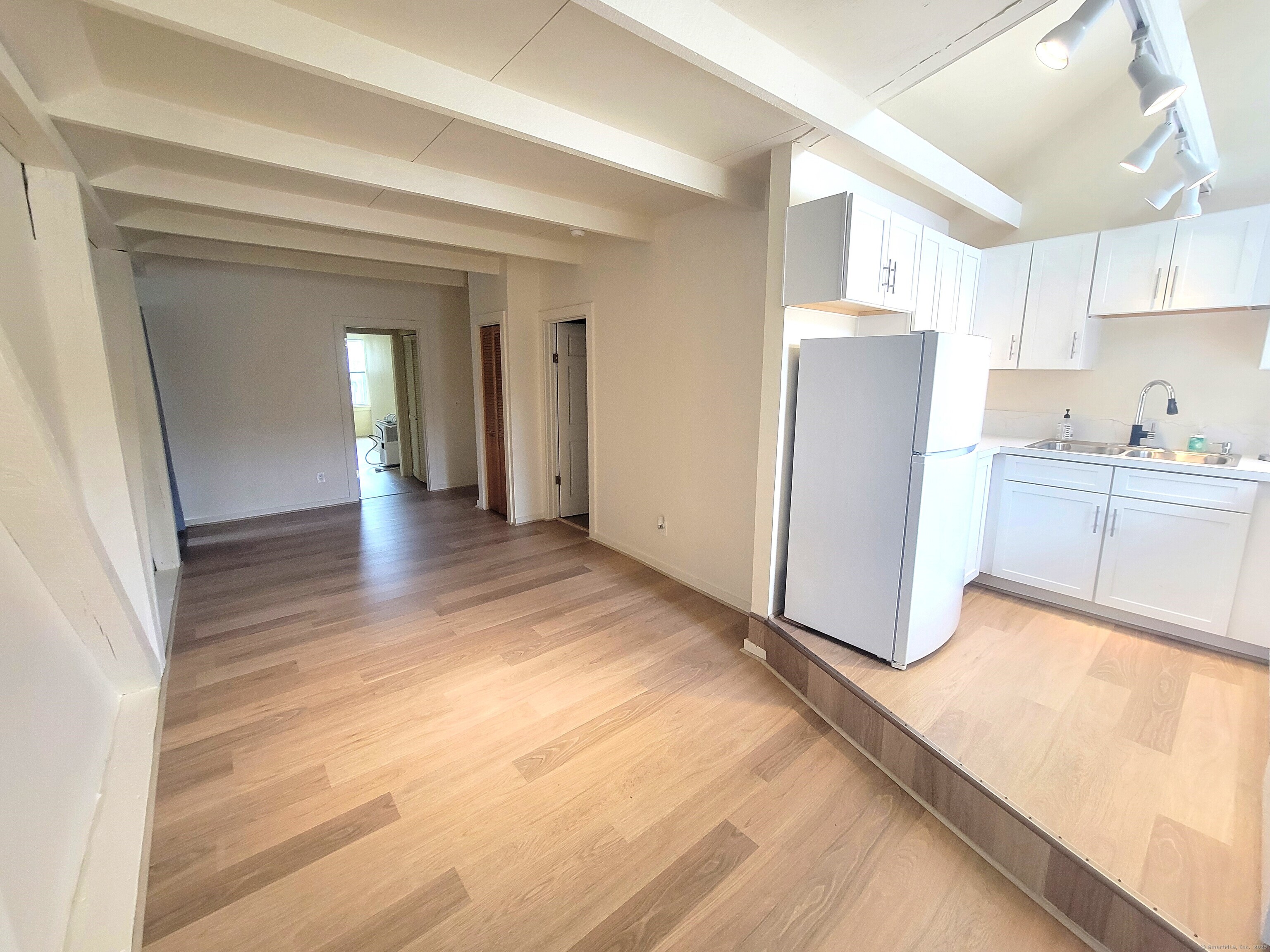 270 Cherry Brook Road, Unit 3 Canton, CT 06019 - Photo 6 of 13 a view of a kitchen with wooden floor and a refrigerator