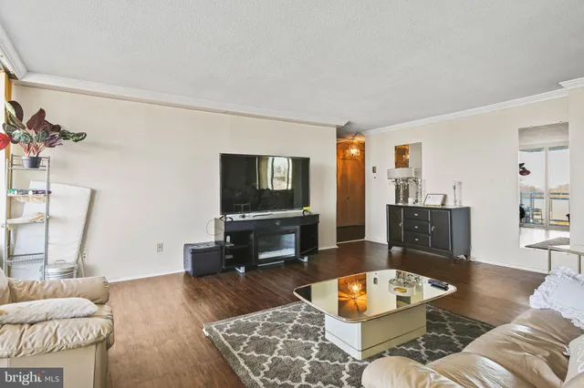 a living room with kitchen island furniture and a chandelier