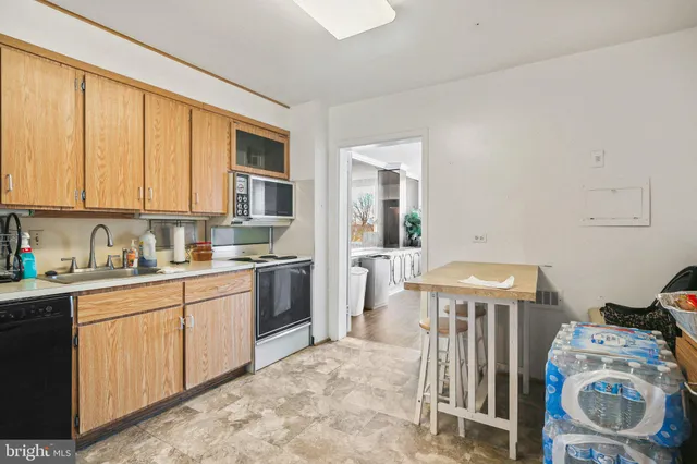 a kitchen with a sink a refrigerator and a stove