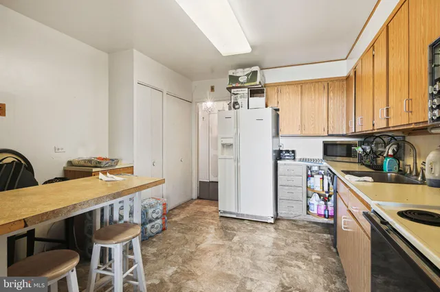 a spacious bedroom with a bed and a flat screen tv