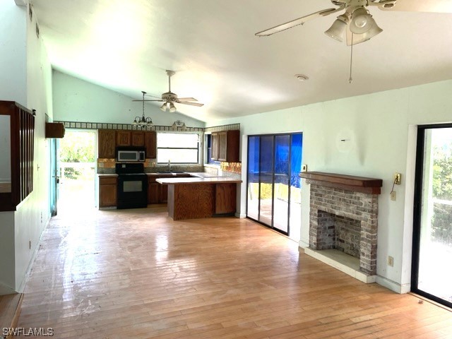 6670 Sun Rise Lane Bokeelia, FL 33922 - Photo 12 of 13 a large kitchen with cabinets and stainless steel appliances