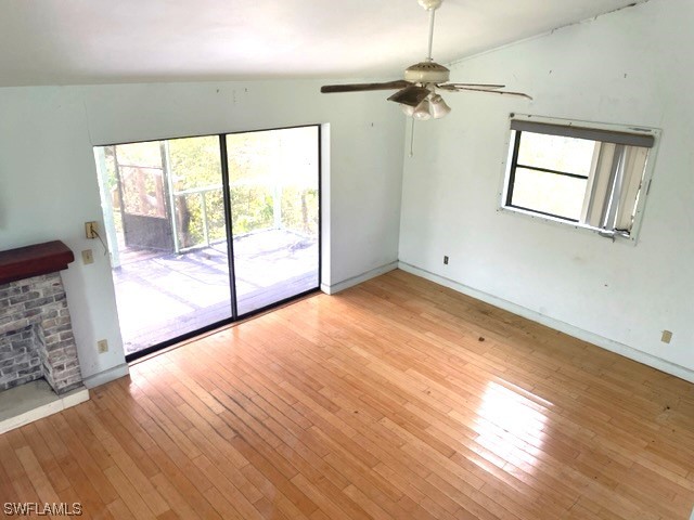 6670 Sun Rise Lane Bokeelia, FL 33922 - Photo 3 of 13 wooden floor in an empty room with a window