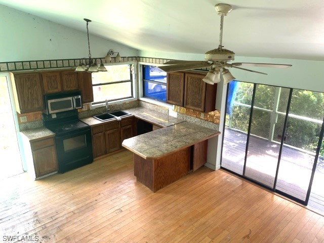 6670 Sun Rise Lane Bokeelia, FL 33922 - Photo 4 of 13 a kitchen with stainless steel appliances granite countertop a sink stove and refrigerator