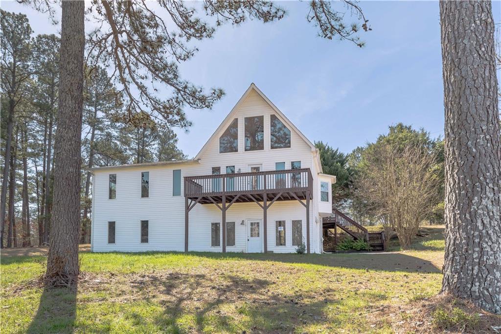 395 Tom Jones Road Kingston, GA 30145 - Photo 1 of 1 a view of a house with a big yard and large tree