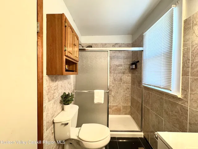 a bathroom with a toilet a sink and a shower