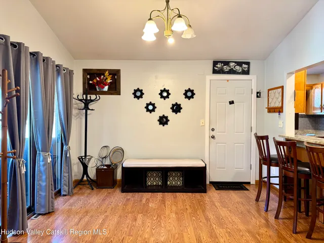 a spacious bedroom with a bed and a chandelier