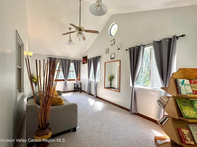 a living room with furniture a window and a flat screen tv