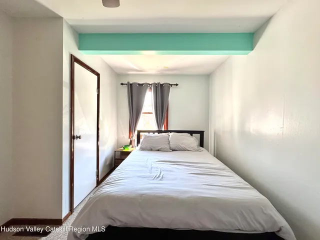 a bedroom with a large bed and a large window