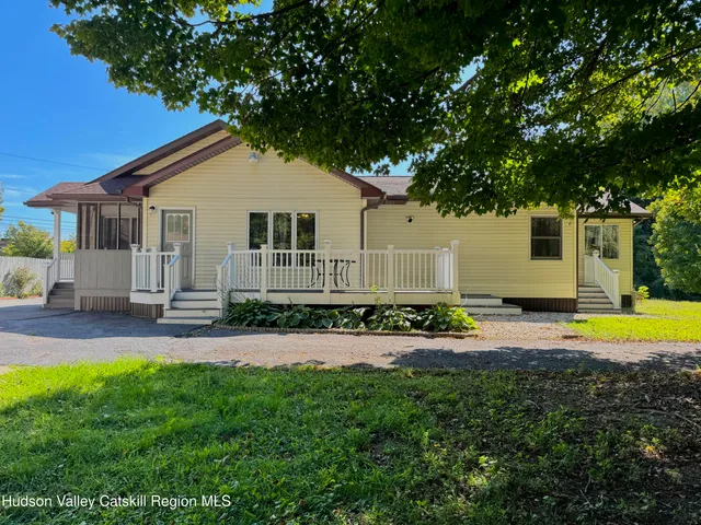 a house with swimming pool in front of it