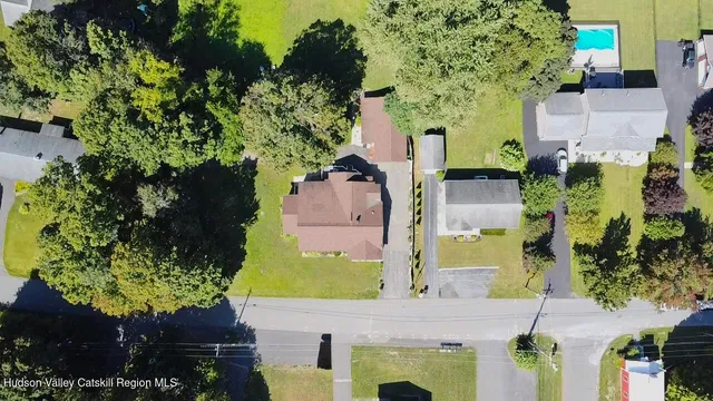 an aerial view of a house with a yard