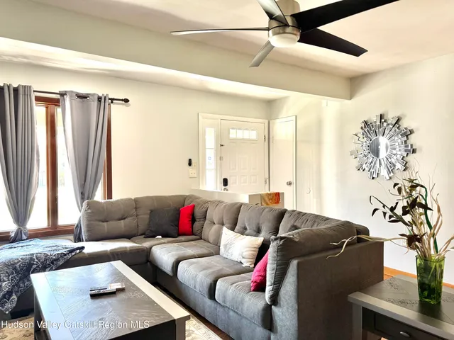 a living room with furniture and a potted plant