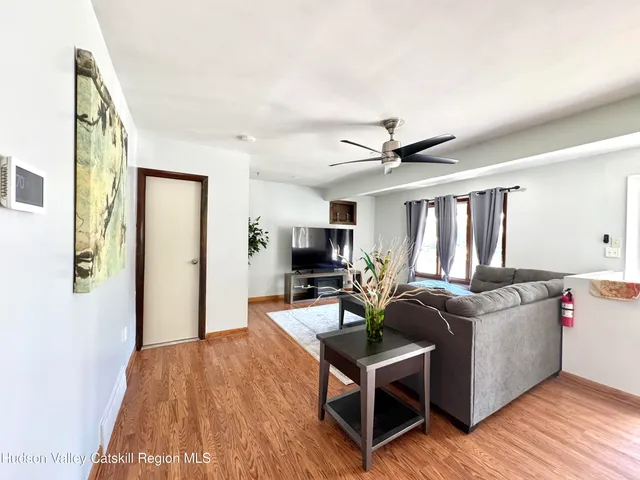 a living room with furniture and a wooden floor