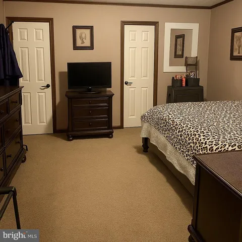 a bedroom with a bed and a dresser