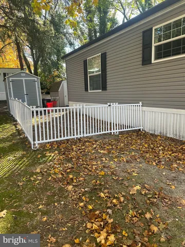 a view of a house with wooden fence