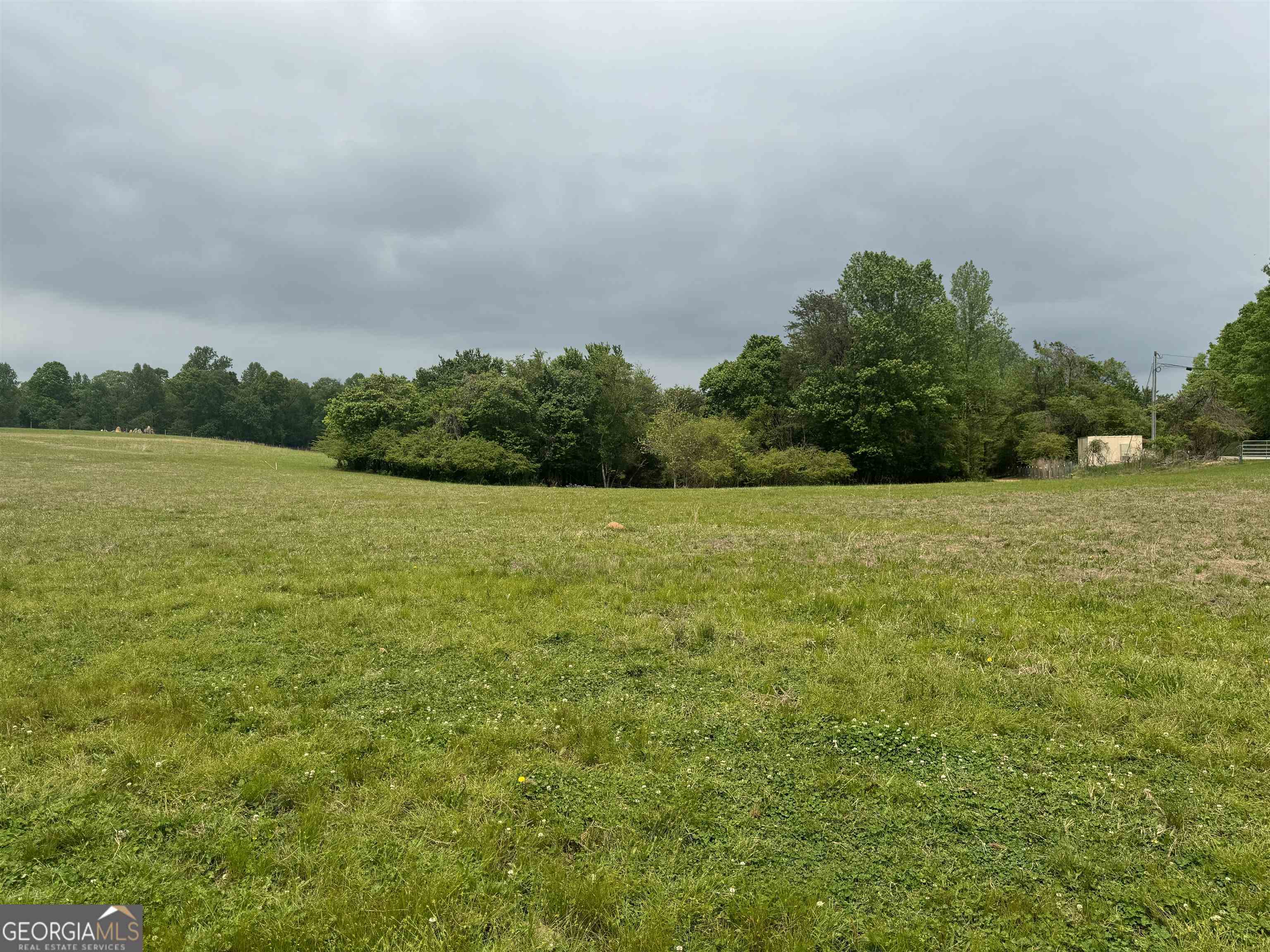 a view of a field with an ocean view