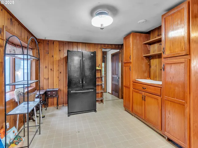 a kitchen with stainless steel appliances granite countertop cabinets and refrigerator