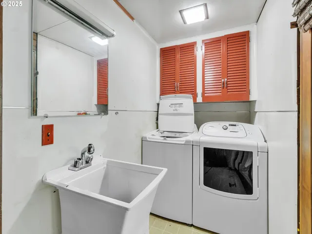 a kitchen with a sink and a stove top oven