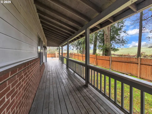 a view of a balcony with wooden floor