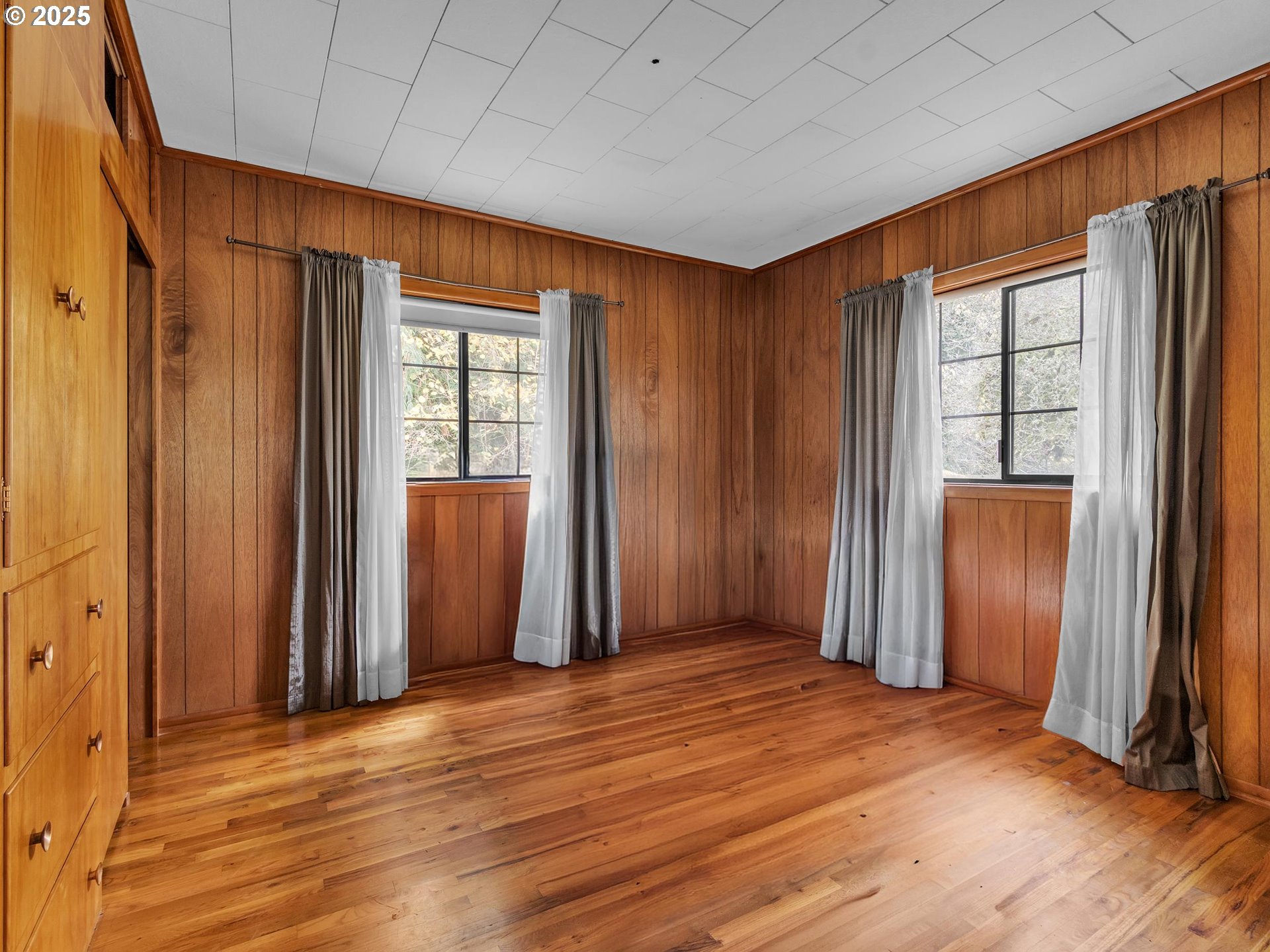 707 Northeast Carty Road Ridgefield, WA 98642 - Photo 5 of 31 an empty room with wooden floor and a window