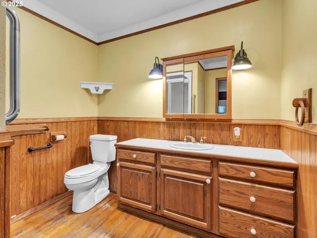 a bathroom with a sink a toilet and a mirror