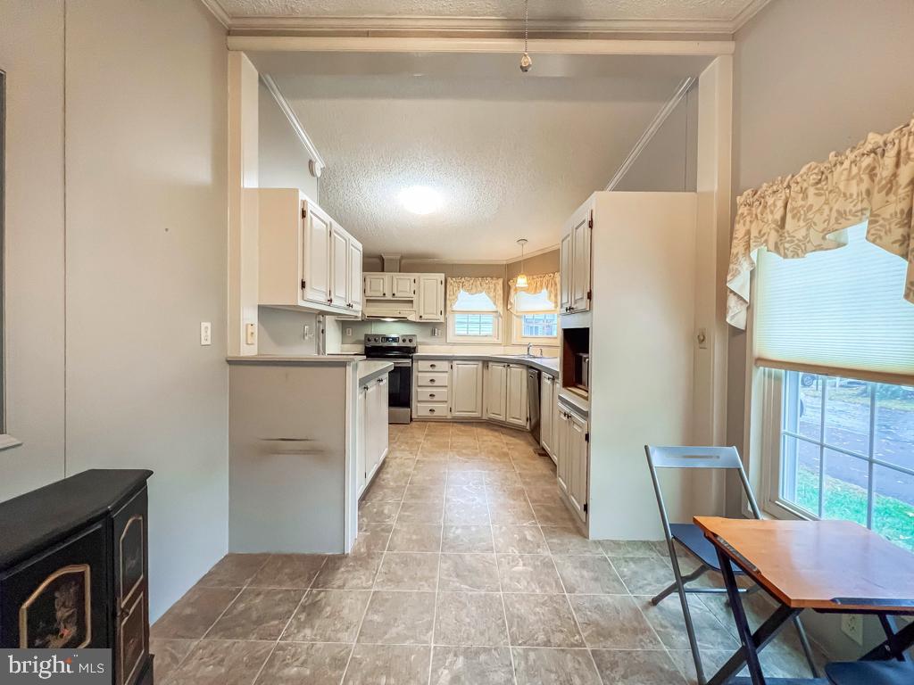 13 Clovedale Way Souderton, PA 18964 - Photo 14 of 33 a kitchen with stainless steel appliances granite countertop a refrigerator a stove a sink dishwasher and white cabinets with wooden floor