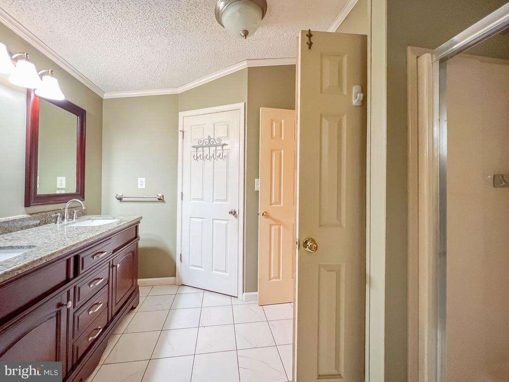 13 Clovedale Way Souderton, PA 18964 - Photo 23 of 33 a bathroom with a granite countertop sink a mirror and a shower