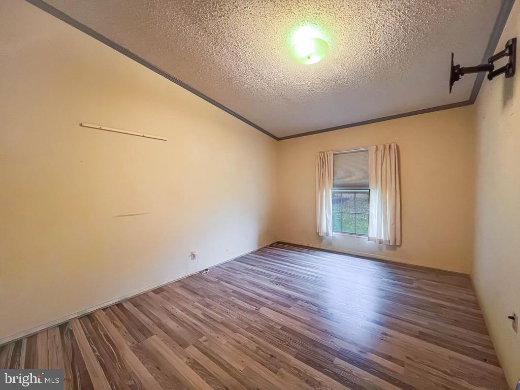 13 Clovedale Way Souderton, PA 18964 - Photo 27 of 33 a view of an empty room with wooden floor and a window