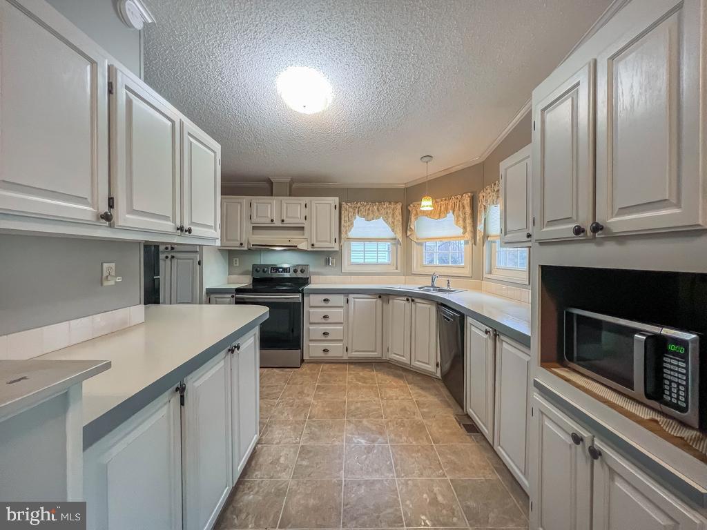 13 Clovedale Way Souderton, PA 18964 - Photo 8 of 33 a kitchen with granite countertop a stove sink and cabinets