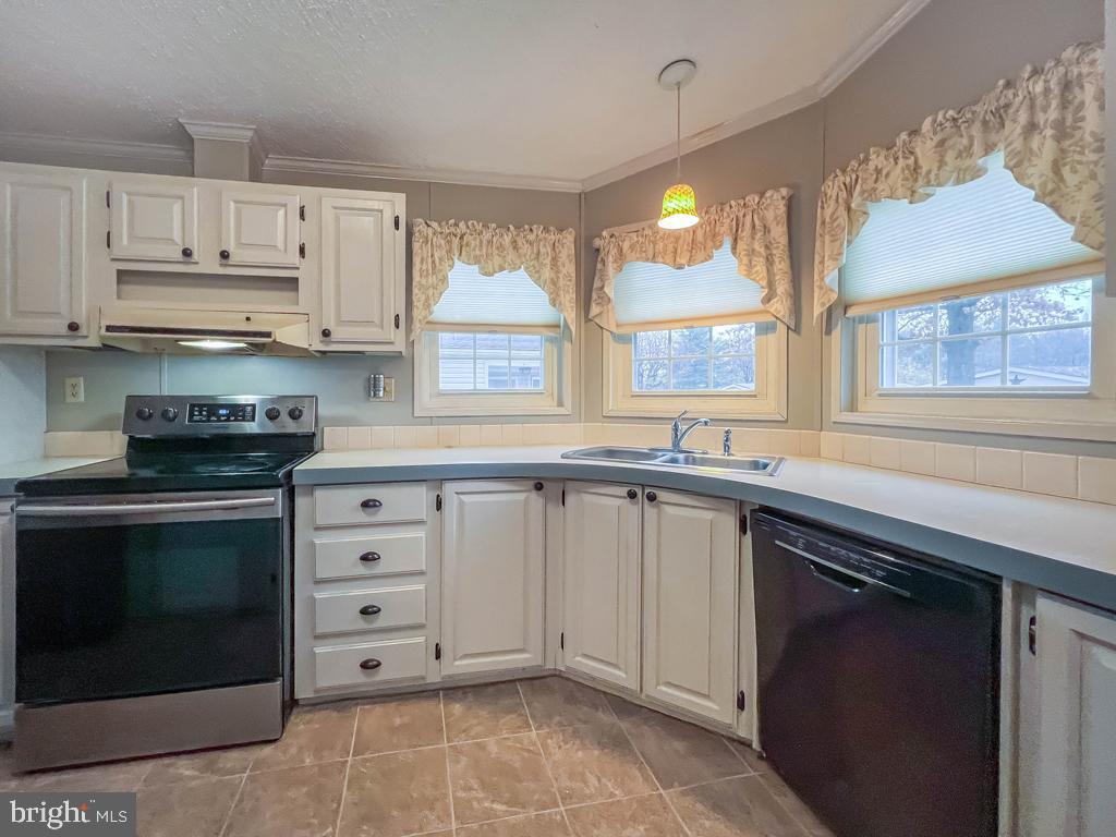 13 Clovedale Way Souderton, PA 18964 - Photo 9 of 33 a kitchen with granite countertop white cabinets and window