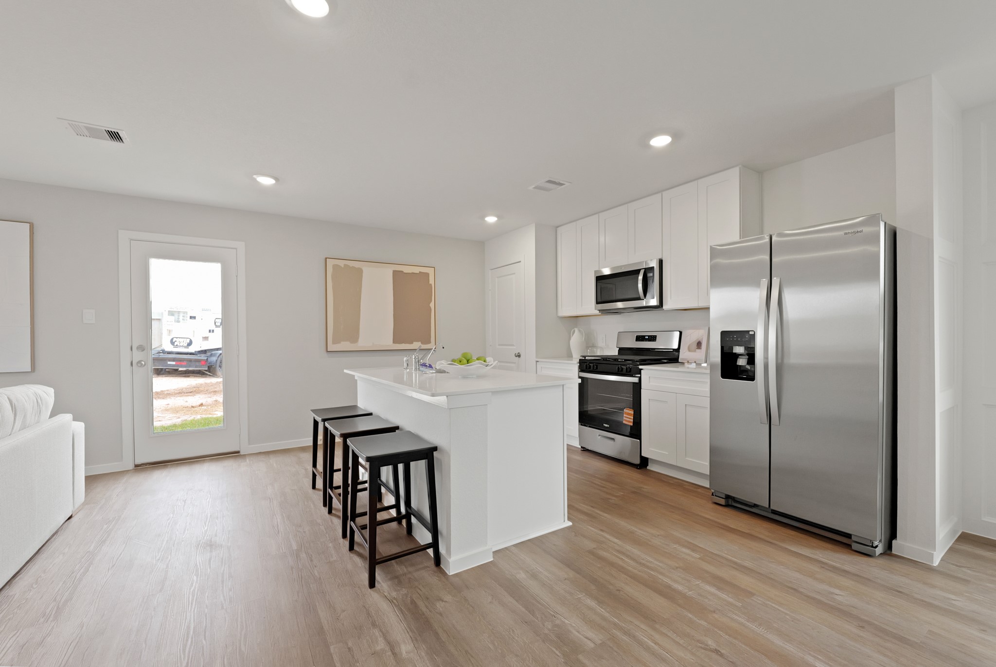 14601 Ivy Floral Way Splendora, TX 77372 - Photo 4 of 23 a kitchen with granite countertop a refrigerator a stove a sink dishwasher and a dining table with wooden floor