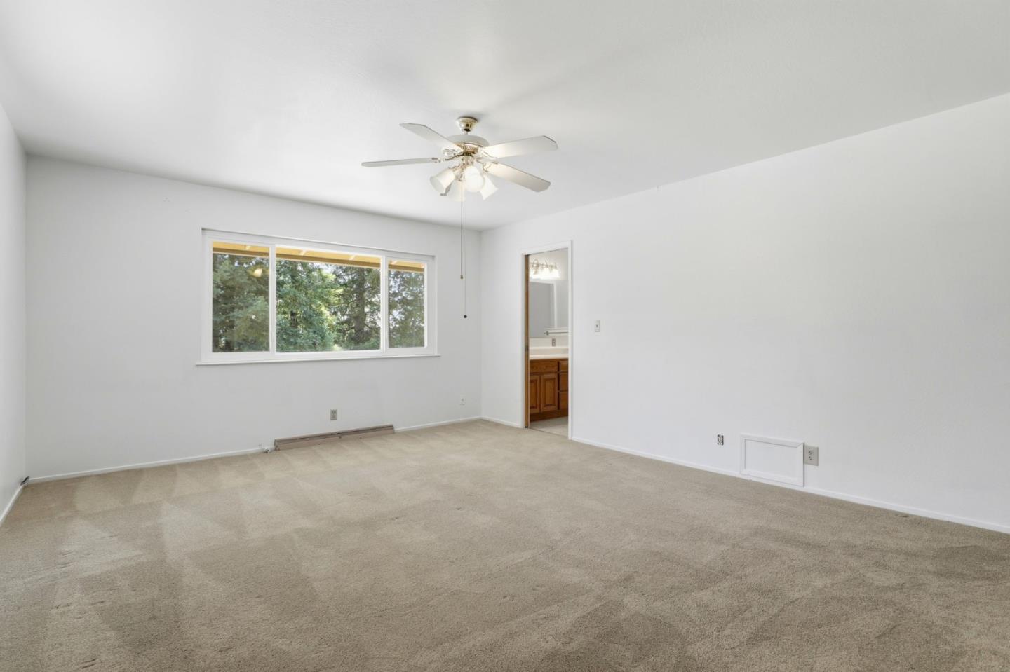 208 Mill Creek Road Fremont, CA 94539 - Photo 19 of 59 an empty room with a window and a ceiling fan