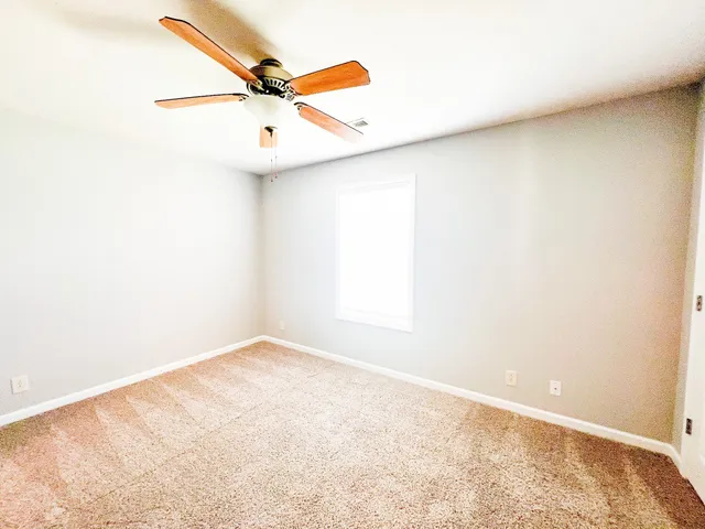 a spacious bathroom with a granite countertop sink and a mirror