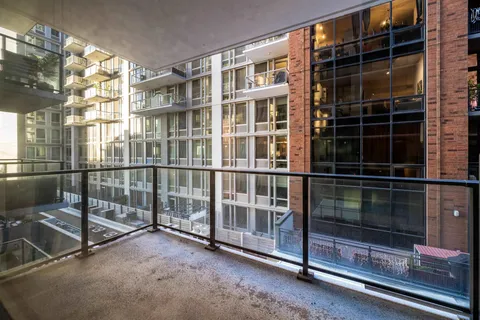 a living room with patio furniture and a potted plant