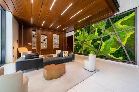 a living room with furniture and large windows