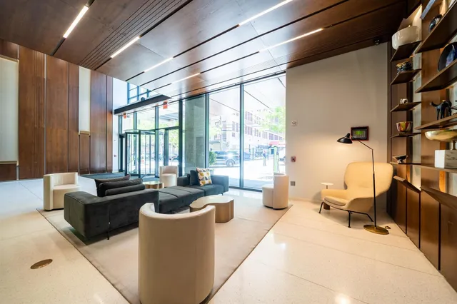 a view of a hallway with wooden cabinets