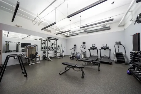 a living room with furniture and a dining table with wooden floor