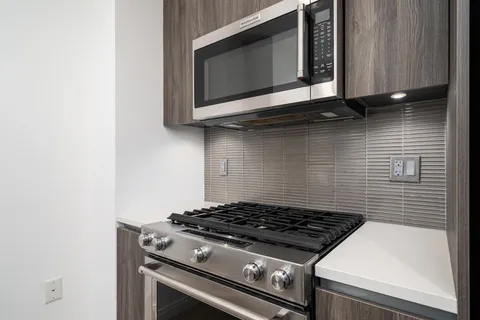 a stove top oven sitting inside of a kitchen