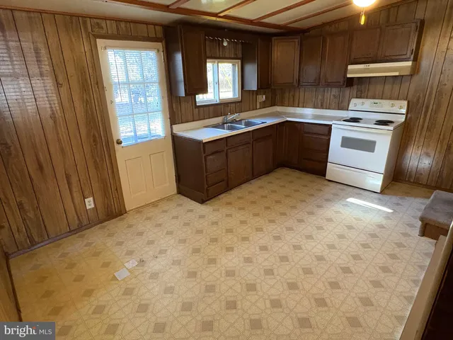 a kitchen with stainless steel appliances granite countertop a stove sink and cabinets