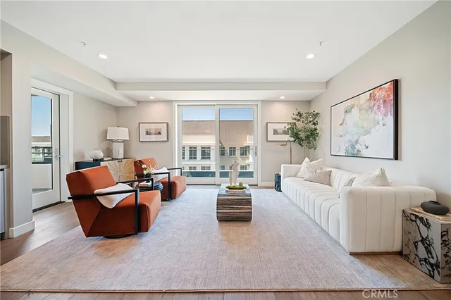 a living room with furniture a rug and a large window