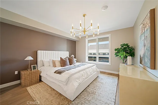 a bedroom with a bed and a potted plant