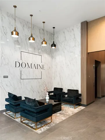 a living room with furniture and a chandelier