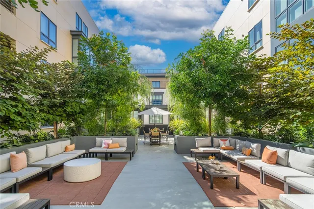 a view of a patio with table and chairs and potted plants